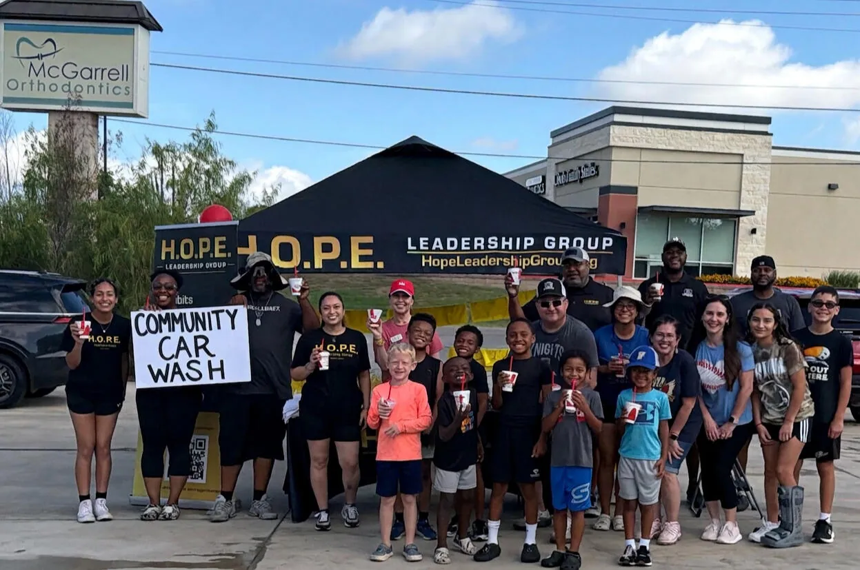 Mentors and mentees participate in a H.O.P.E. Leadership Group community car wash